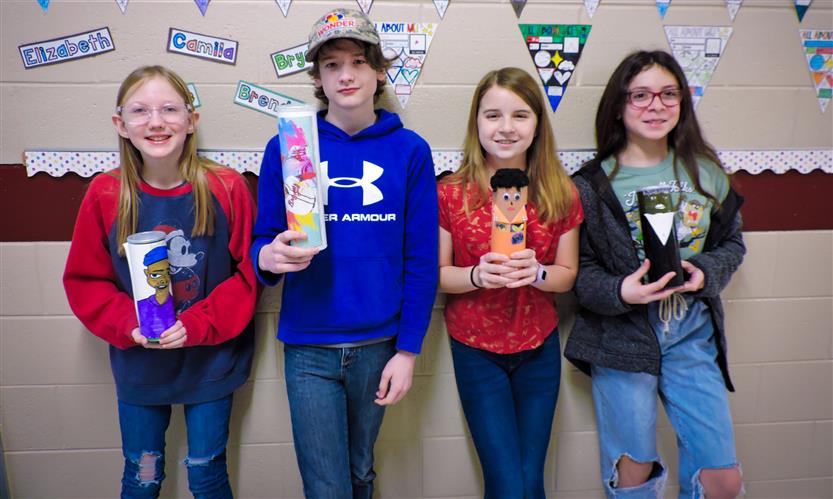 Students hold up Characters in a Can